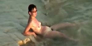 Sunburned woman is naked on a beach (Catch My)