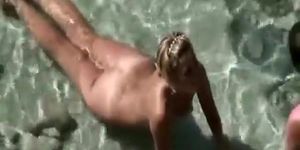 Blonde nude plays with cock in water