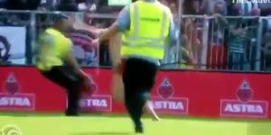 Streaking guy runs around the football pitch