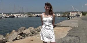 Melany gives a blowjob while relaxing on a public place