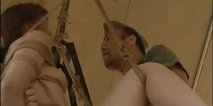 Asian slut hanging on some ropes fucked by the soldiers