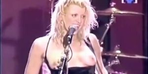 Hot rockstar plays a song with her tits out in the open
