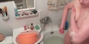 Hot woman washes in the bathtub