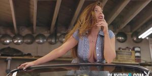 Curvy redhead MILF shows her assets in a garage on top of a car (Melrose Michaels)