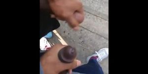 Black amateurs stroke big cocks outdoors