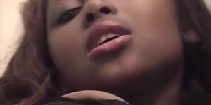 Busty African girl plays with her shaved pussy