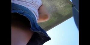 A candid cam view up the jeans skirt reveals a sweet ass