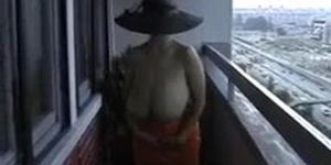 Busty wife strips nude on balcony