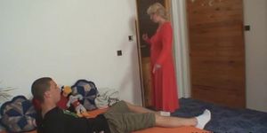 Mature blonde woman helping the young lad jerk off