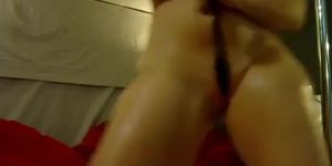 Sexy oily wet brunette girl in bikini stripteasing and seducing on webcam