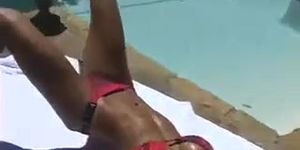 Ashley Lawrence sunbathing by the pool