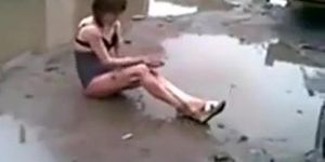 Drunk girl in muddy puddle