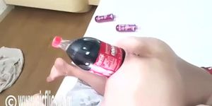 Massive cola bottle is penetrating the asshole of a busty slut