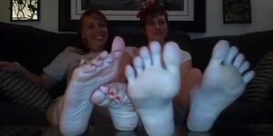 short hair girl and blondie friend showing her feet and playing with them