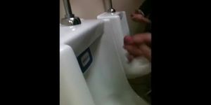 two slim dicks getting wanked at the urinals