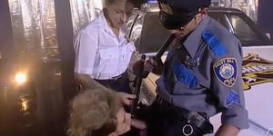 Two officers take care of the blonde