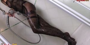 Tattooed redhead takes a shower and masturbates in catsuit