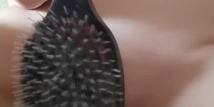 Naked shaved pussy is spanked with big hairbrush