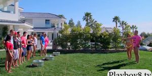 Swinging couples playing with water guns