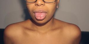 Sexy ebony in glasses playing with sexy mouth