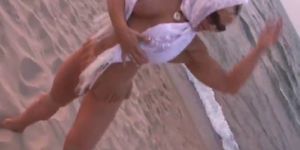 Dorothy struts topless along the beach