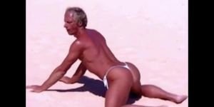 Tanned guy on beach in tiny string thong temporarily