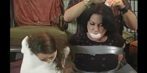 Two girls are wrap gagged and tormented