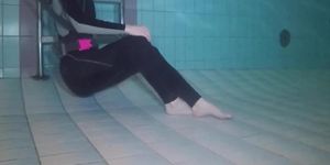 Breath holding underwater girl dressed in overalls wetlook barefeet feet