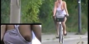 Hot woman exposing nipple while biking, preten ...