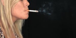Sexy blonde girl smoking & dangling while putting on makeup