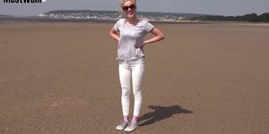 Girl in White Jeans Rolling in the Mud at Beach