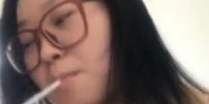 Chinese blonde Woman smoking slim during cigi break with her toyboy