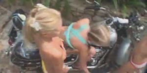 Three naked babes washing Harley Davidson