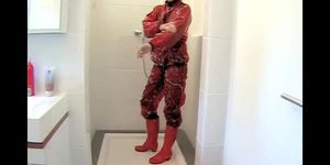 shower in red PVC and rubber boots