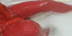Wet fetish in red latex milf playing with big black dildo in bath