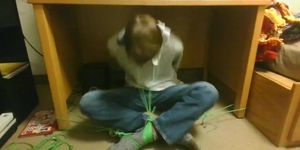Teen boy tied up under desk in wool socks