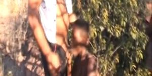 Busty African slave blowing long cock outdoor