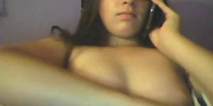 Teen girl masturbating on web cam while talking on a phone