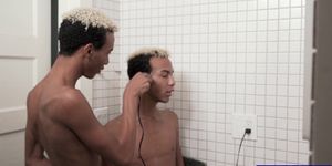 Twin brothers cut each others hair in the bathroom