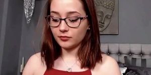 Incredible young redhead beauty smoking sexy in glasses