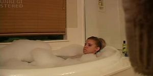 Sexy blond girl caught playing with herself in the bath
