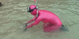 Veronica snorkelling on the beach in pink latex