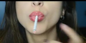 Gorgeous young brunette girl giving sexy smoking dildo blowjob