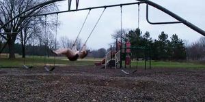 Young Lady naked in public Park on Swing