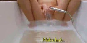 darkhair playing with shower in bathroom - video 2