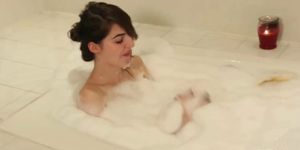 Bathing tgirl suds up then pees in tub