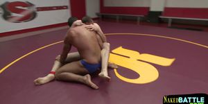 Naked muscular hunks wrestle and roll around