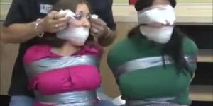 Two tied girls are gagged and blindfolded