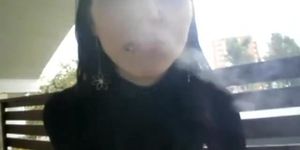 Amazing young brunette girl smoking with nose exhales
