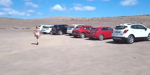 Naked pissing in beach car park